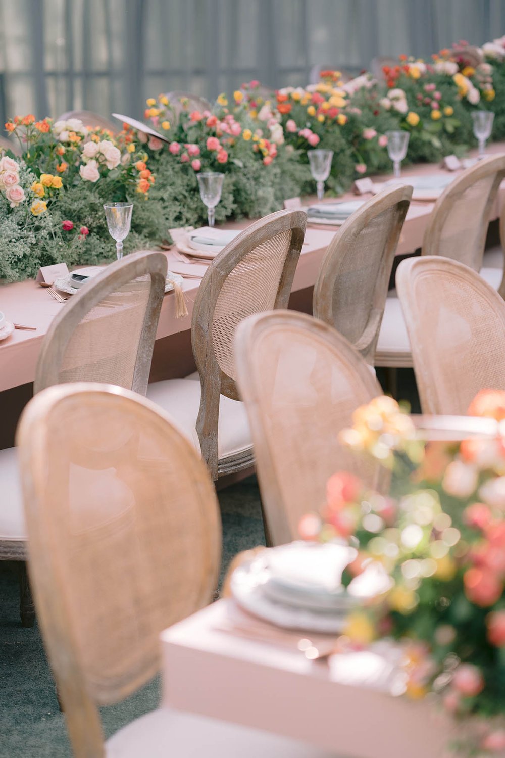 Colorful spring wedding florals on long dining tables - an LA reception designed by Eddie Zaratsian Lifestyle and Design