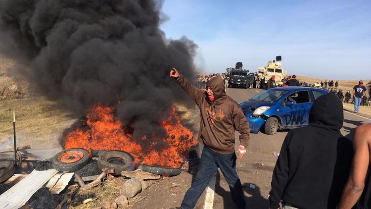 Protesters confront soldiers and law enforcement officers assembled Thursday to force Dakota Access pipeline opponents off private land. (Mike McCleary / Bismarck Tribune)