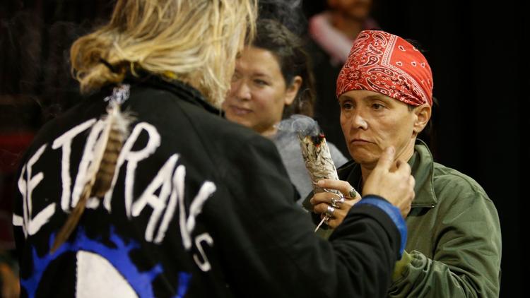 Tribal members conduct a cleansing ceremony for the veterans who traveled to North Dakota to oppose the Dakota Access oil pipeline. (Mark Boster / Los Angeles Times)