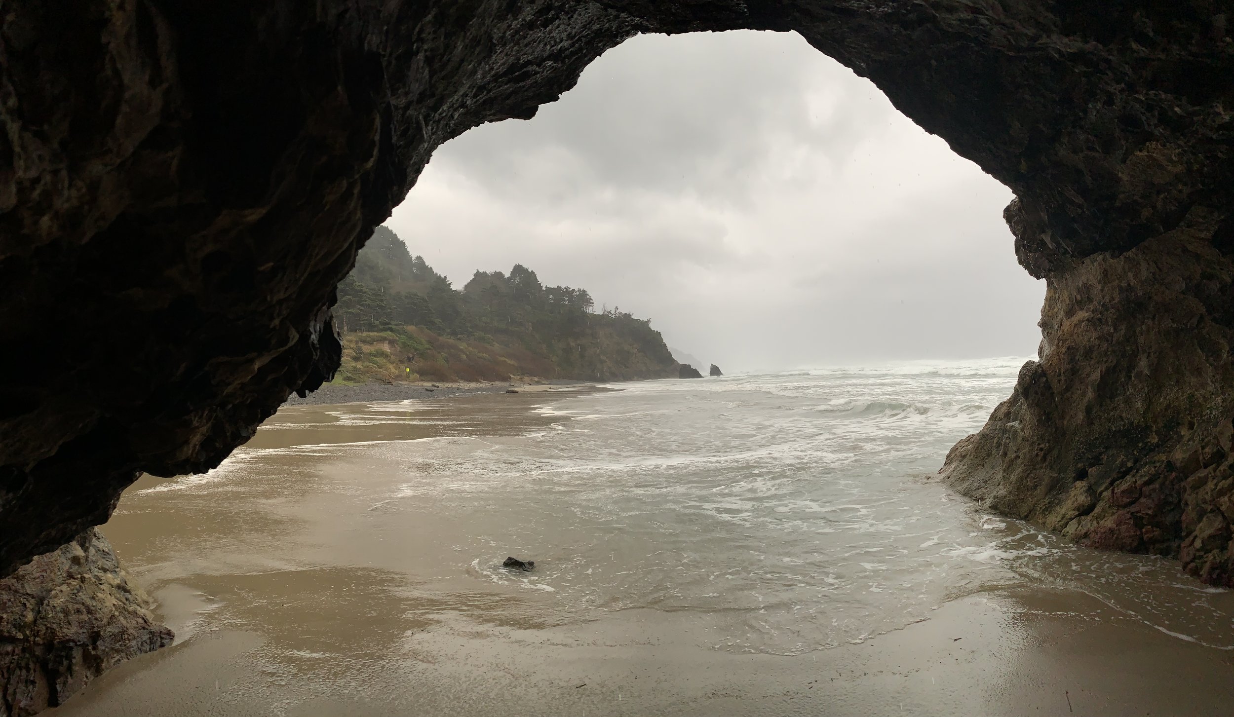 Sheltered from the rain, but then a wave got my feet!