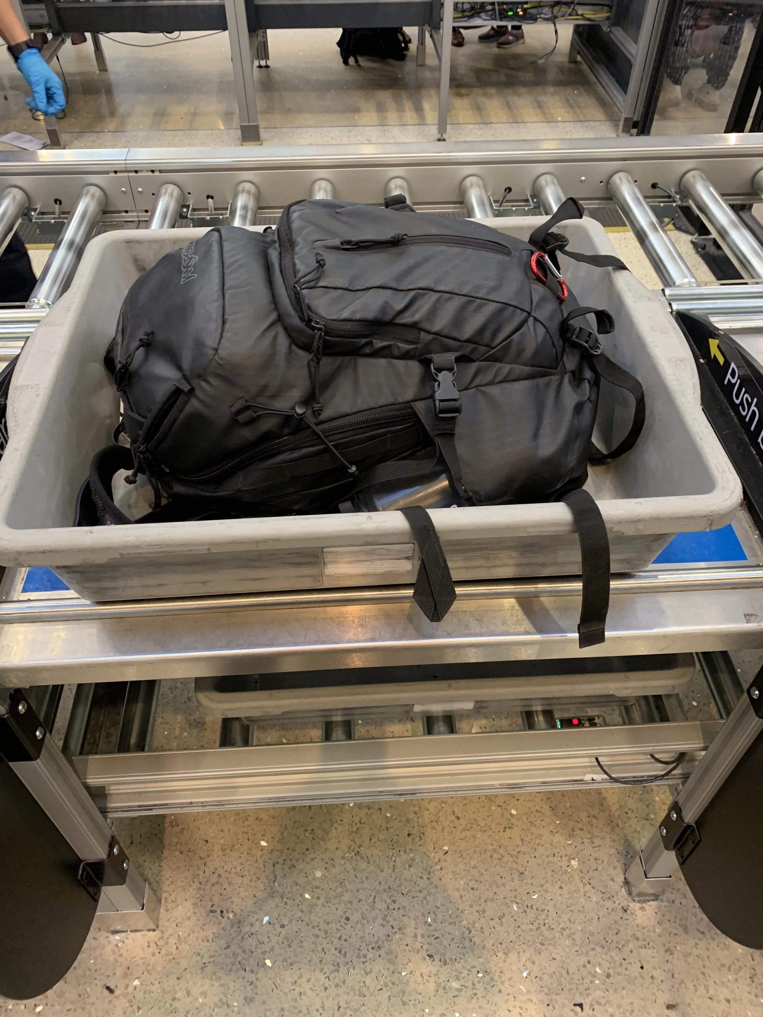 This style of security check point is so much better. You stand at one spot and fill up tubs until you’re ready to walk through. No more hopping down the line with one shoe off!