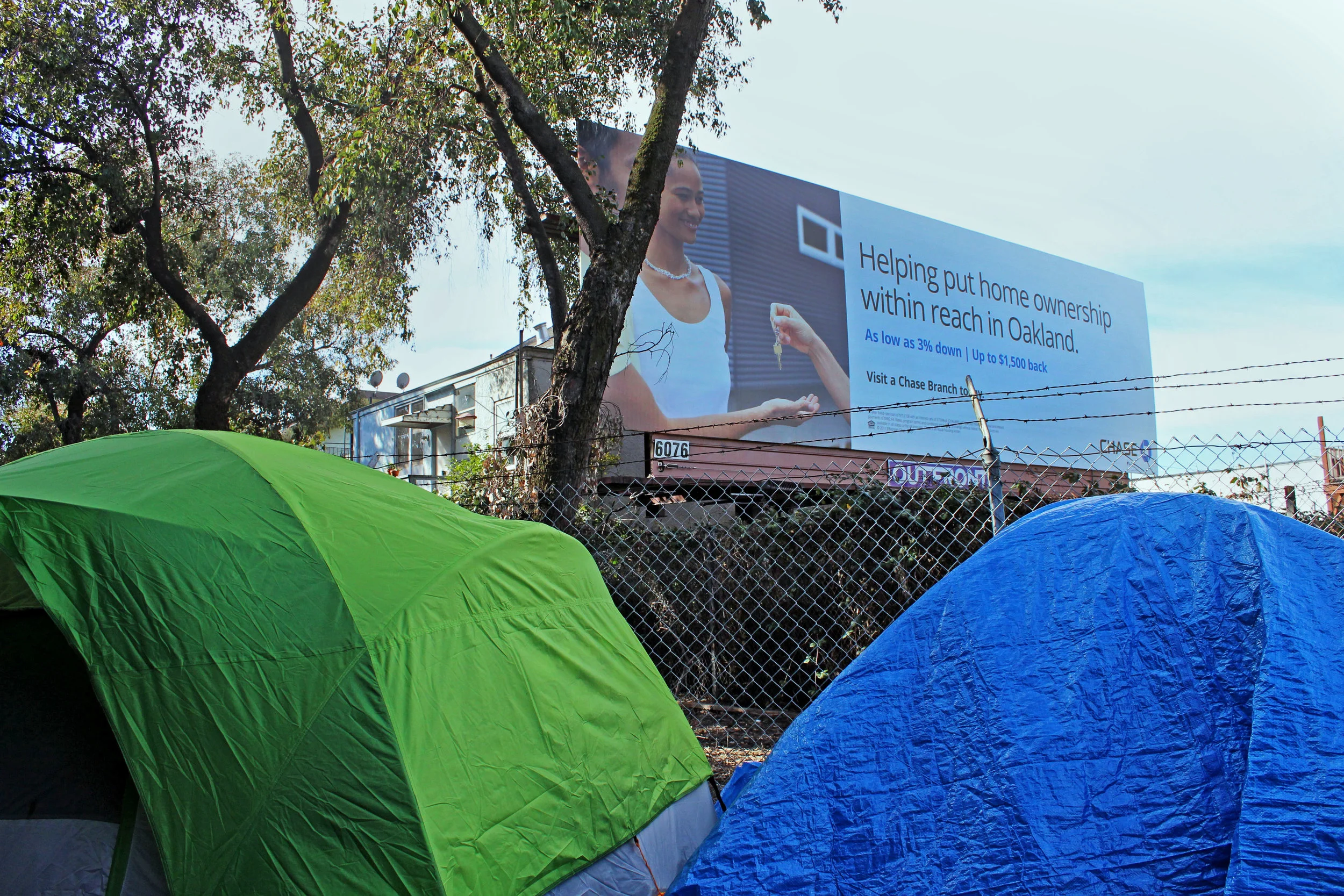 The Northgate encampment stands in the shadow of a Chase Bank billboard advertisement. The "A House in Oakland" team has left this billboard untouched.