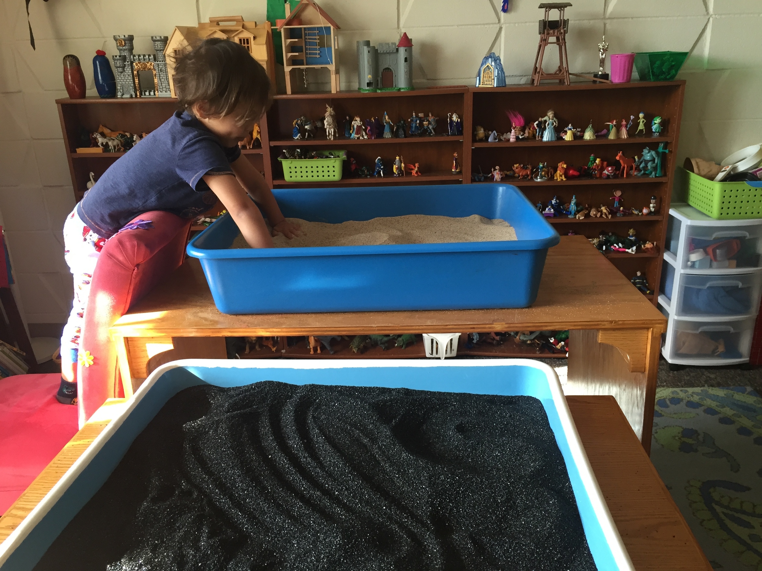 Child touching sand in Sandplay box. And view of Renee's office. 