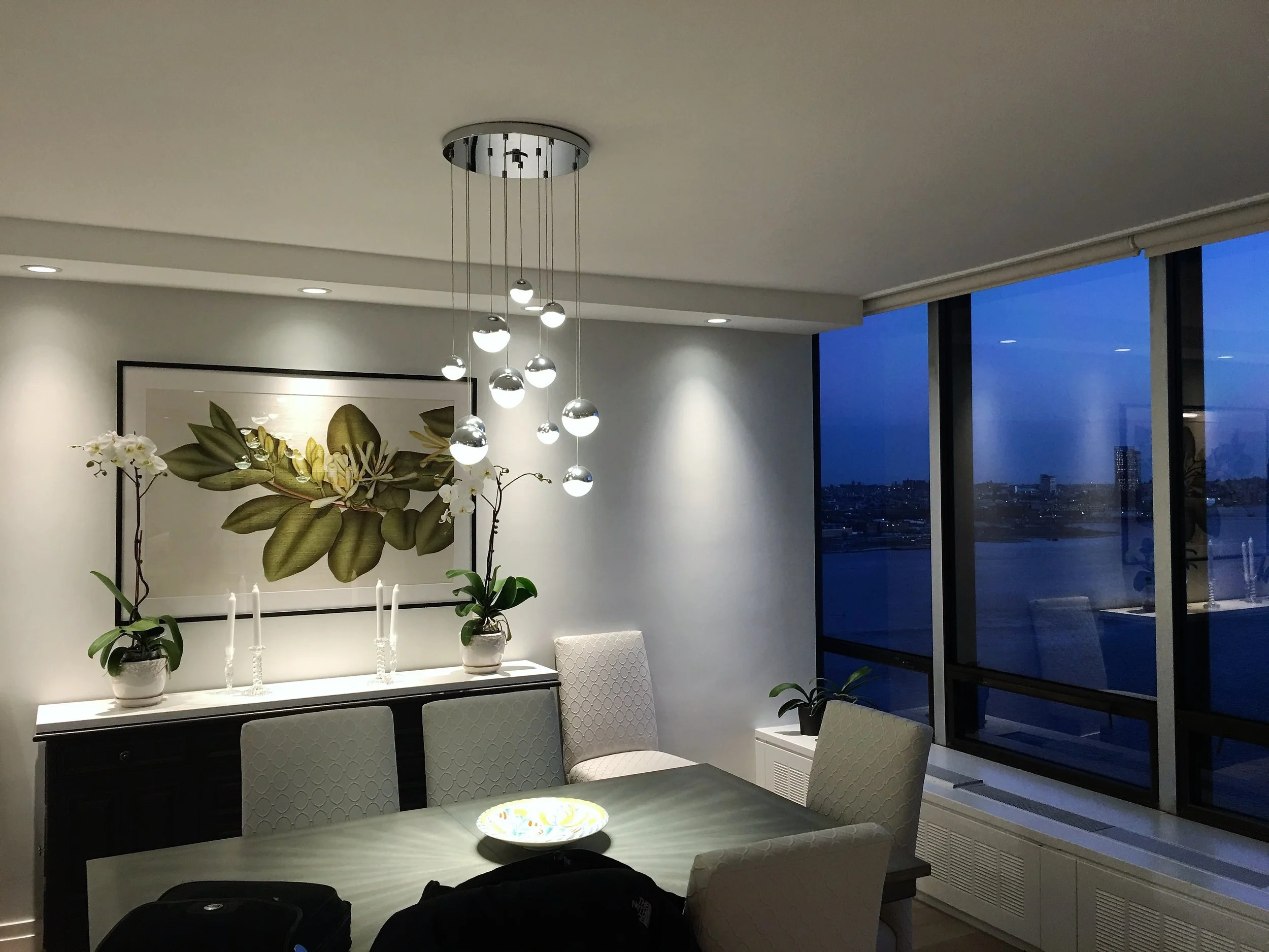  Elegantly illuminated by a modern deco chandelier that adds a touch of sophistication to the contemporary space. 