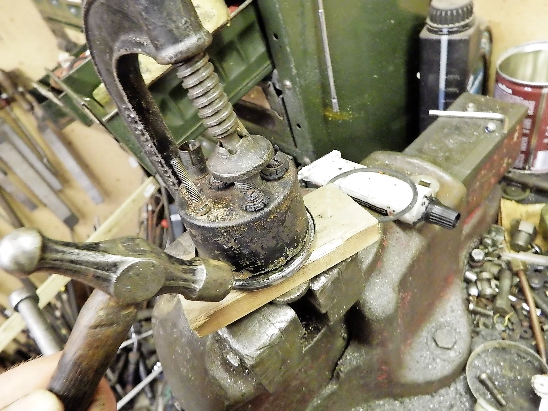 3. By lightly clamping the speedo down onto the rim, the rubber seal is held in compression. To crimp the rim, move round tapping it carefully with a light hammer.
