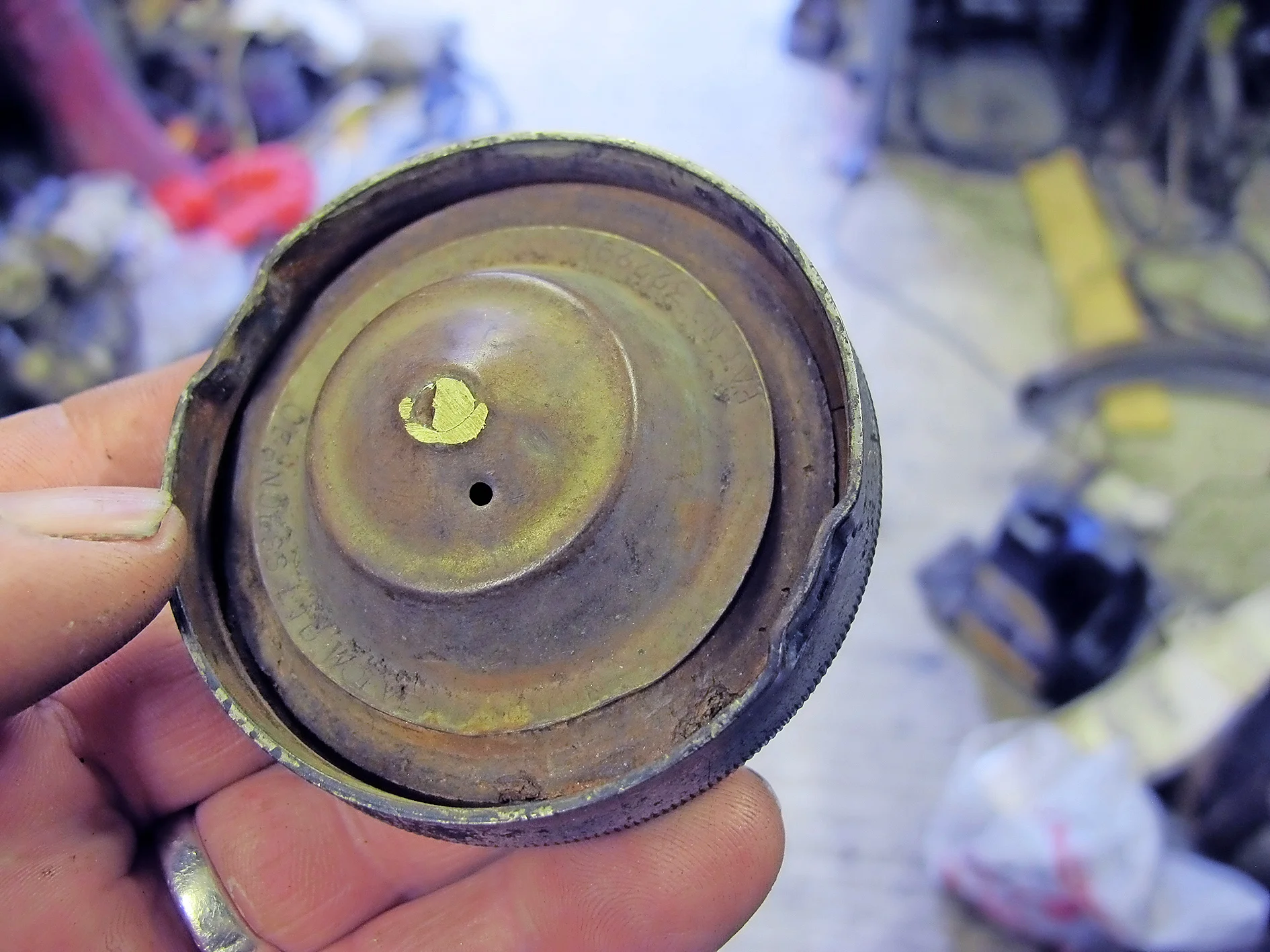 1. I wanted to re-use the Rudge’s original cap, but the seal had gone. The first step was to grind off the peened-over rivet that holds the cap halves together.
