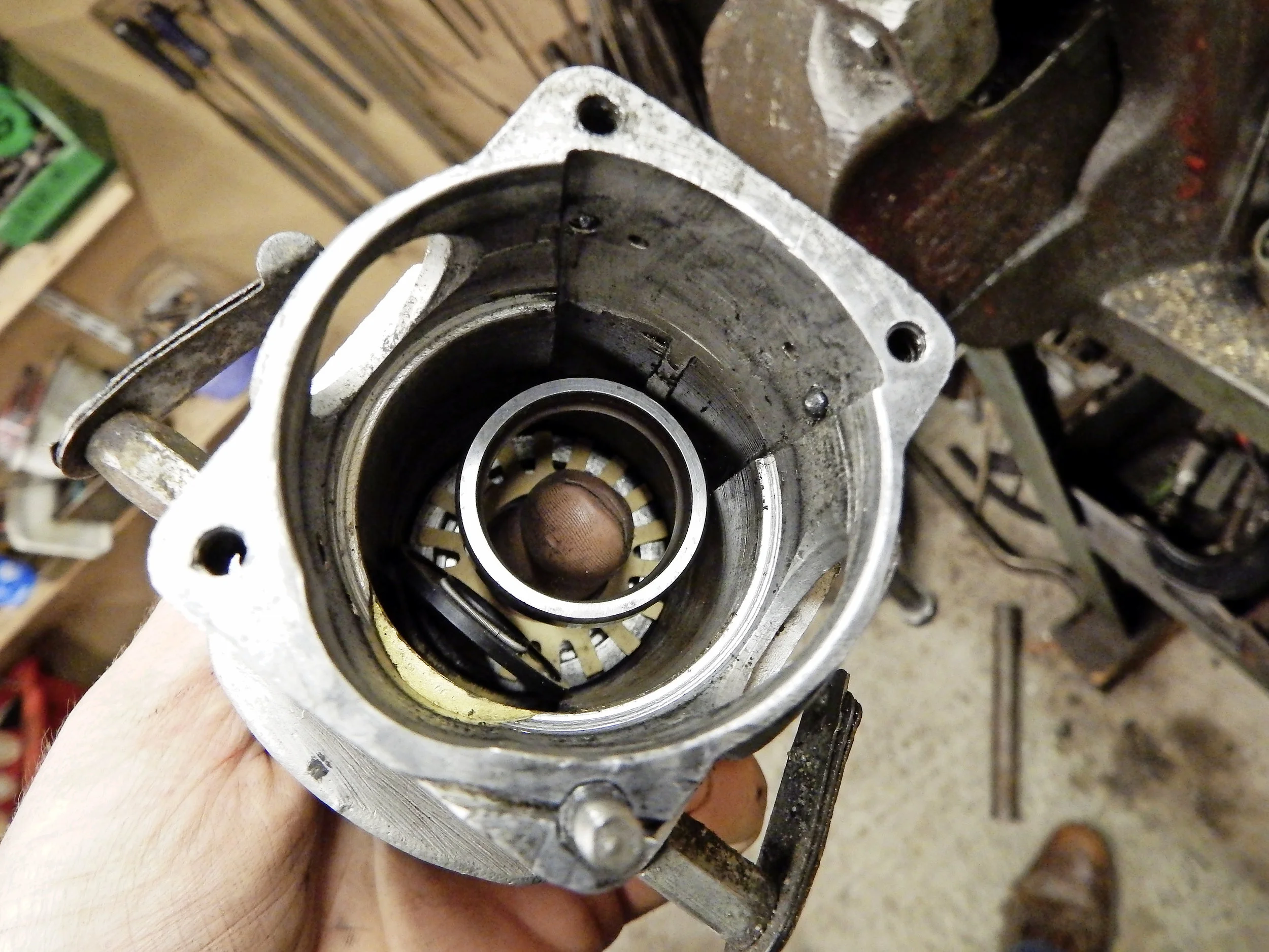 1. The small bore of the oil seal prevents using your finger to hold the seal, paper cup and bearing in place against the pull of the body’s strong magnet long enough to press it home.