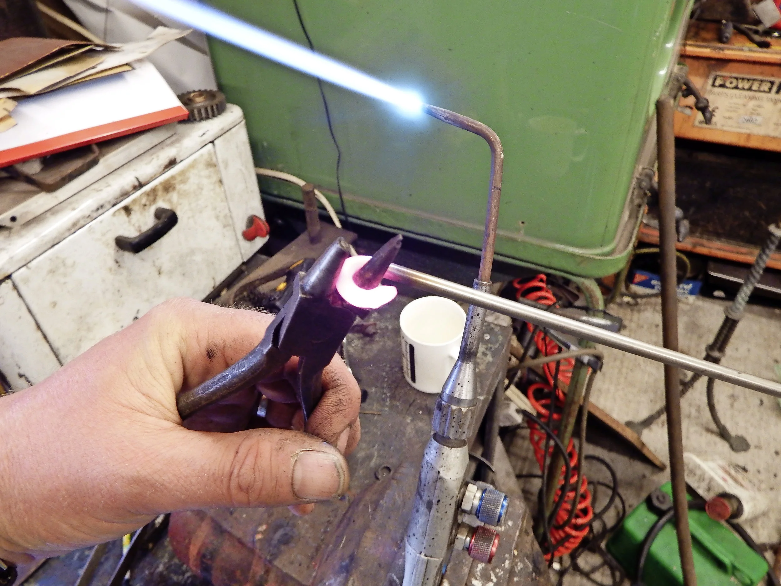 2. With the rod red-hot – propane will do it if you make a firebrick hearth to insulate the heat – you can use the tapered nose as an anvil to bend a loop of the correct radius.