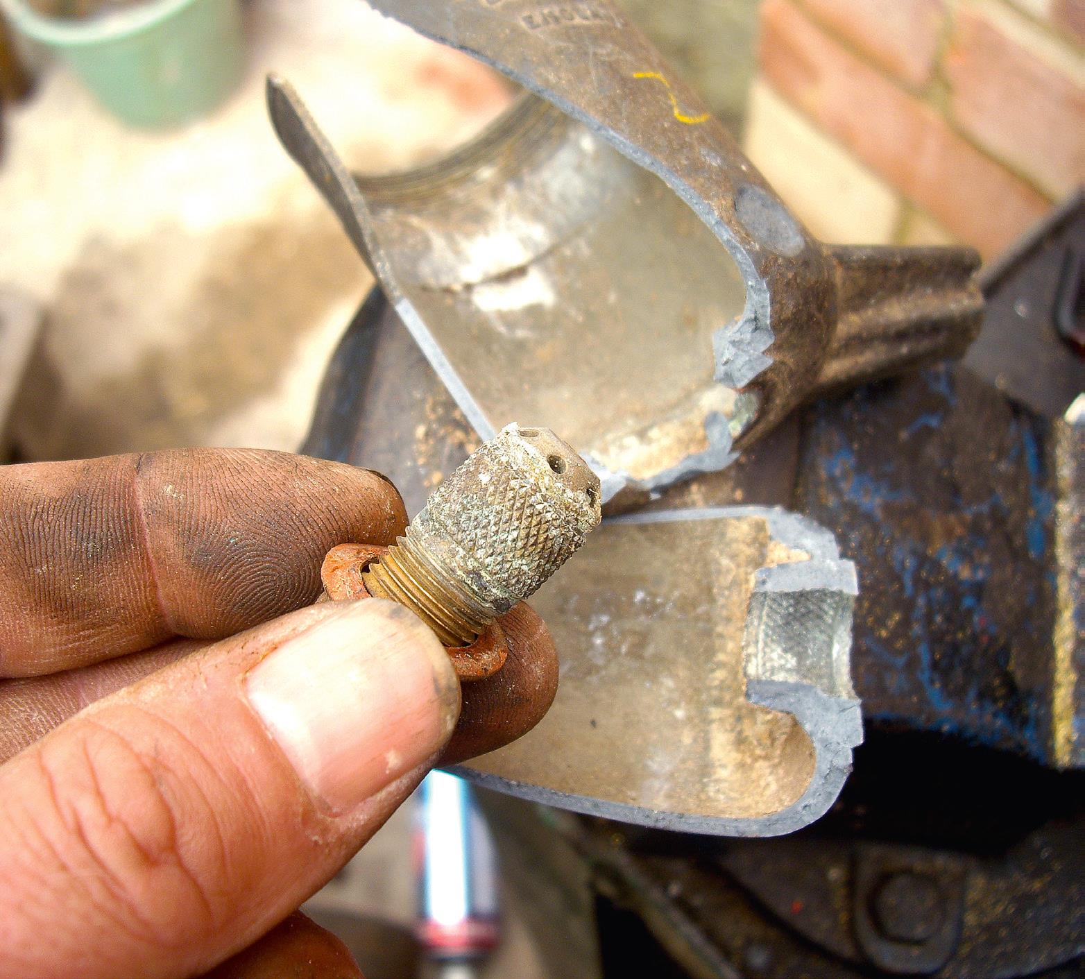 Brass fuel inlet from separate-float Amal looks like it’ll come out... but it won’t, unless you smash it, like this