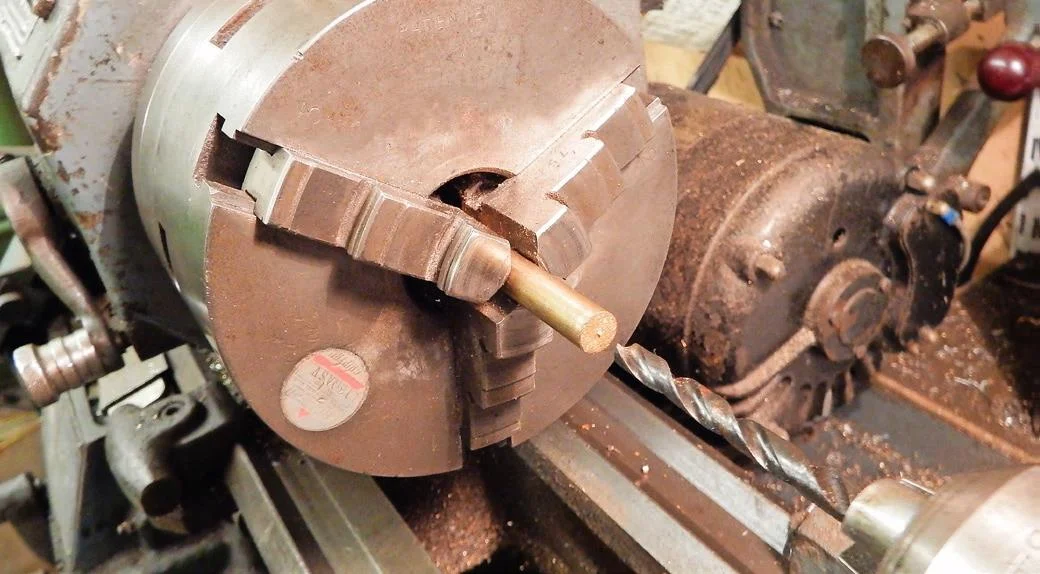1. Drill a hole into the end of a bar; the diameter needs to be the across-flats measurement of the square head.