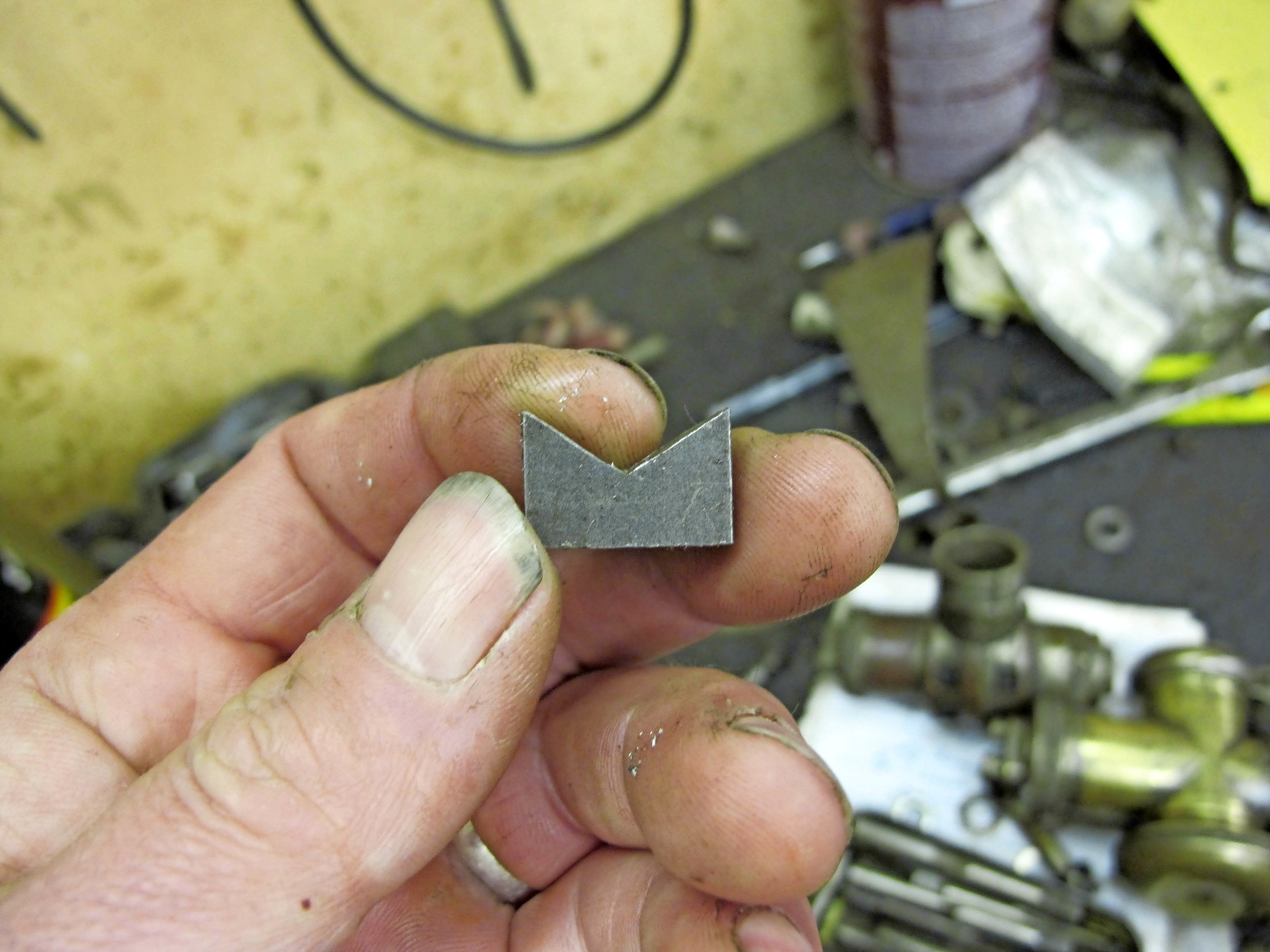 3. Hacksawing along the scored lines to this apex hole produced the correct angle to match two sides of the hexagon. I then cut off the surplus bar.