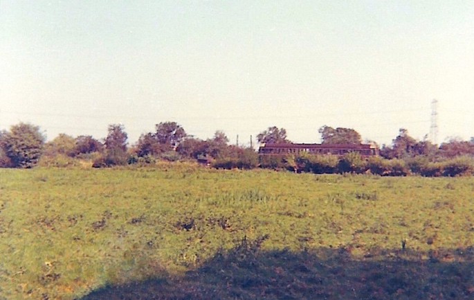 There is a train in this photograph but you might need a moment to spot the railcar heading for the cattle bridge at Staines in about 1962.