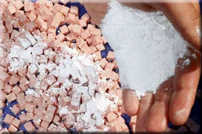 3. Sprinkle the icing sugar over the cubes of luncheon meat