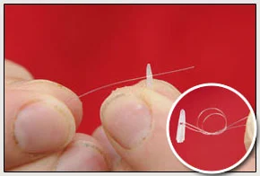 2. First, push your hooklength through a Quickstop and tie it on with a simple overhand knot