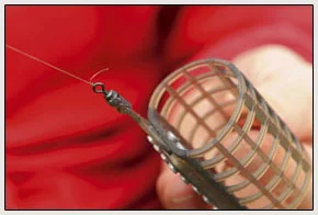8. Now attach your cage feeder to the reel line, again using a proven knot like a grinner or half-blood. Leave a small tag end on the knot as to account for any slippage