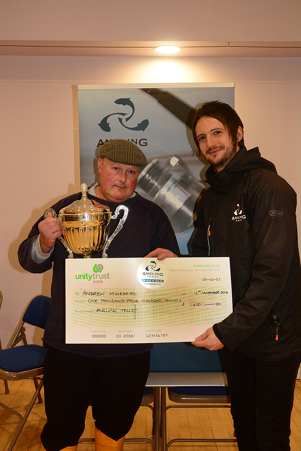 The Angling Trust’s James Roche presents Andrew Muirhead with his cheque. 
