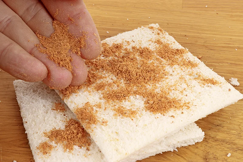 Sprinkle a pinch of krill powder or similar powdered additive on to the bread slices.