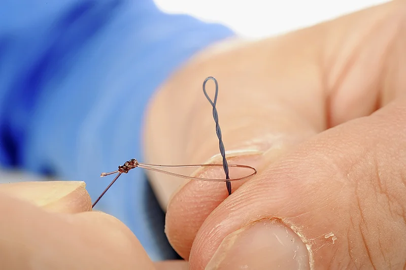 Time to add your hooklength, which you will probably have already tied. Push the hooklength loop over the end of the twisted boom.