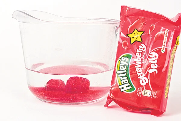 Step 1) Melt the jelly in hot water. Cubed jelly is fine, and you can pick the flavour and colour to suit