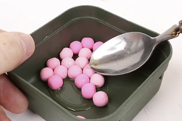 Add a teaspoonful of boilie dip to your chosen hookbaits.Agitate and leave for as long as you can for it to soak in. 
