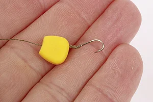 Corn maggot 1 - Tie a size 12 hook to the end of the hooklength and thread on a grain of plastic corn.jpg