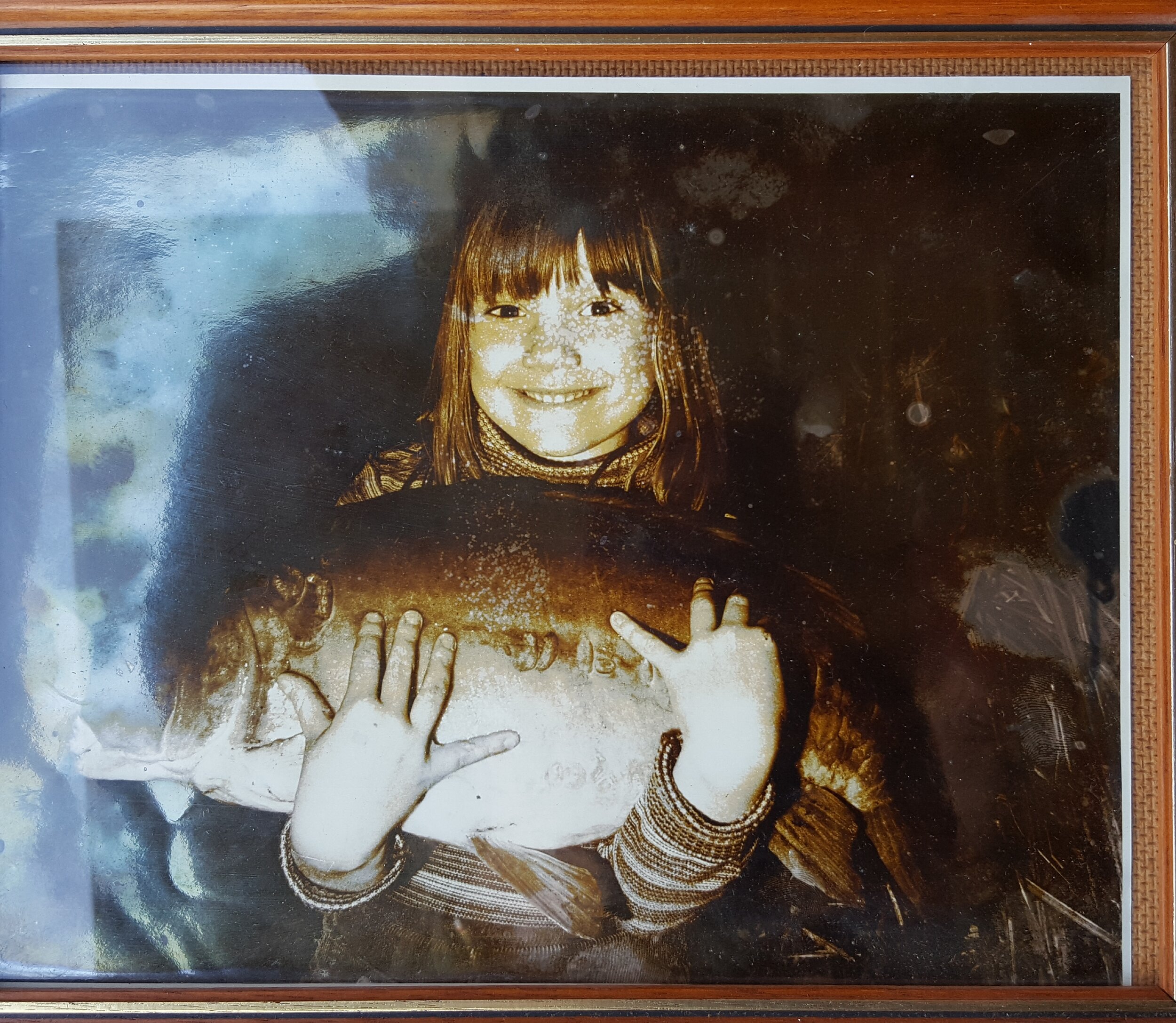 Lisa holding a mirror carp when she was a child.jpg