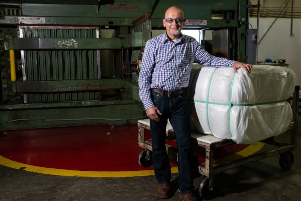 PrimaLoft Product Engineer Robert Dempsey with the first bale of fine denier high performance PrimaLoft biodegradable fibre.