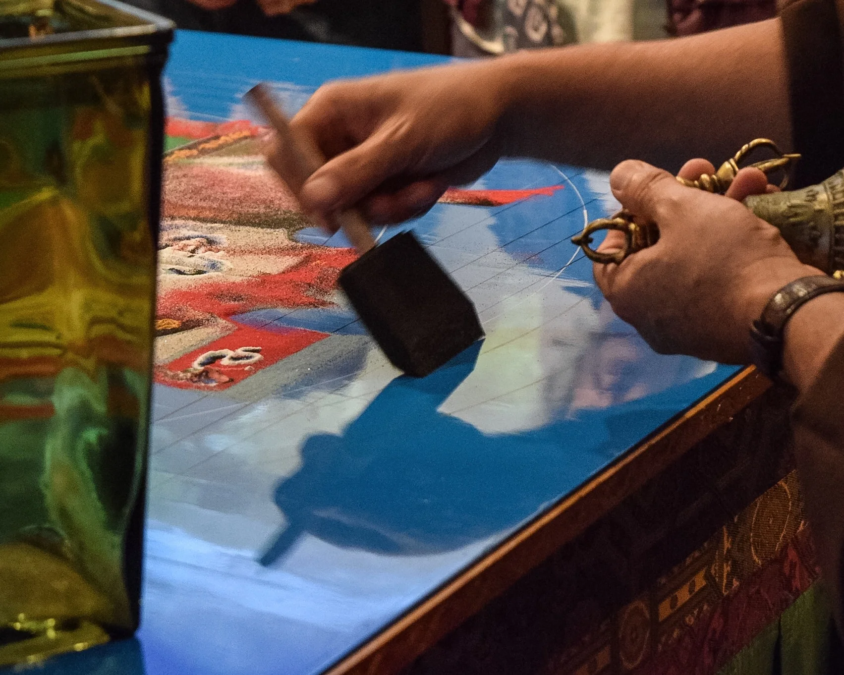During the dismantling, the deity symbols and mandala geometry are removed in a specific order.