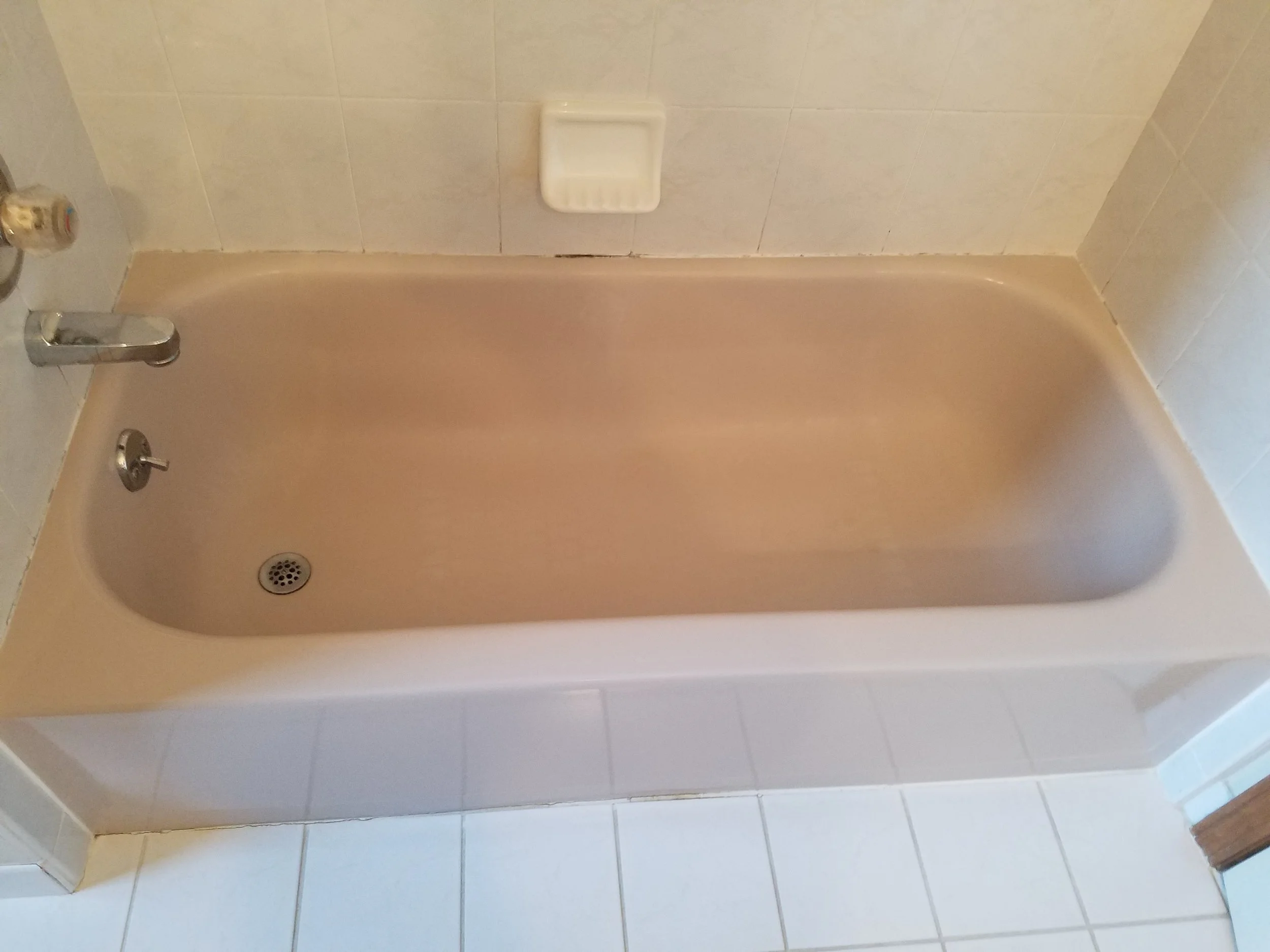 The old caulking on this tub has become stained and begun to separate from the wall.