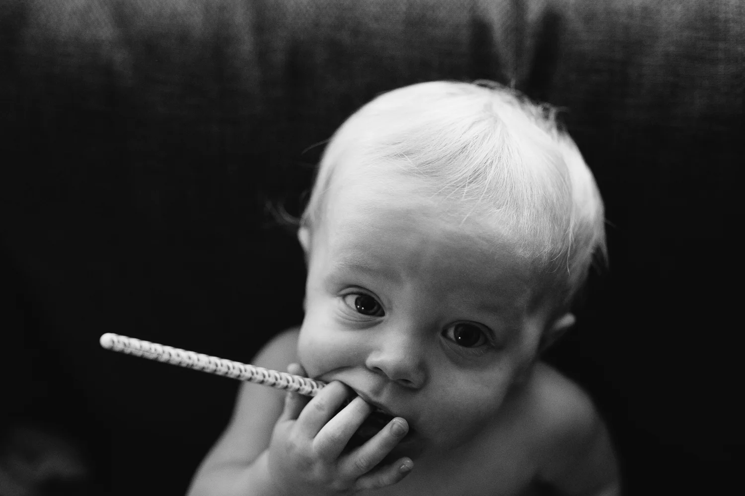1 year old toddler boy with pen on couch - Newmarket child photography