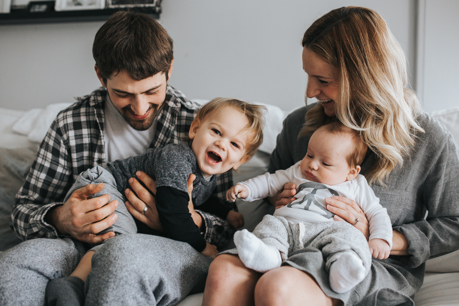 Family of four with two boys on couch - Toddler laughing {Toronto Family Photographer}