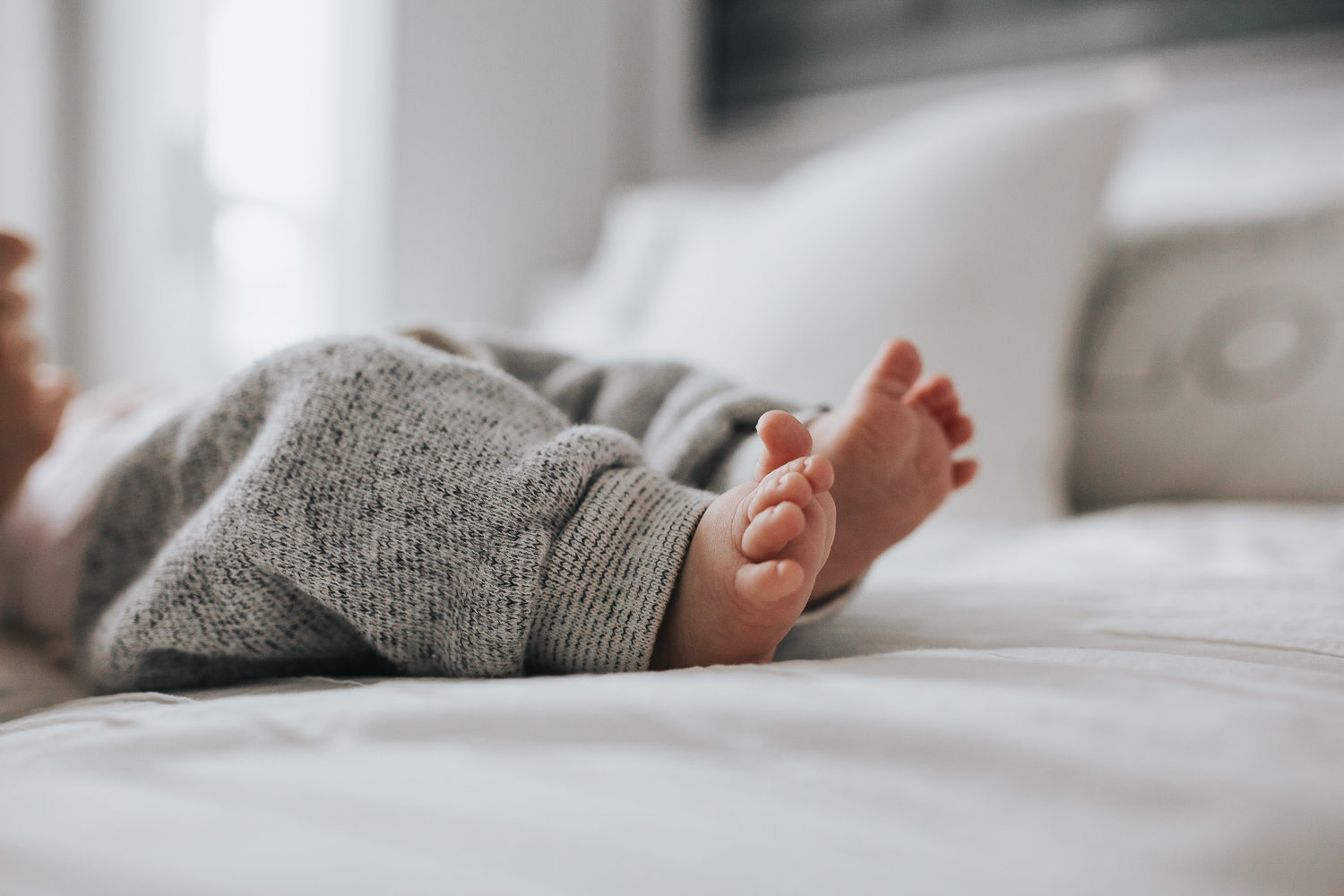 2 month old baby boy feet on bed {Toronto Family Photographer}