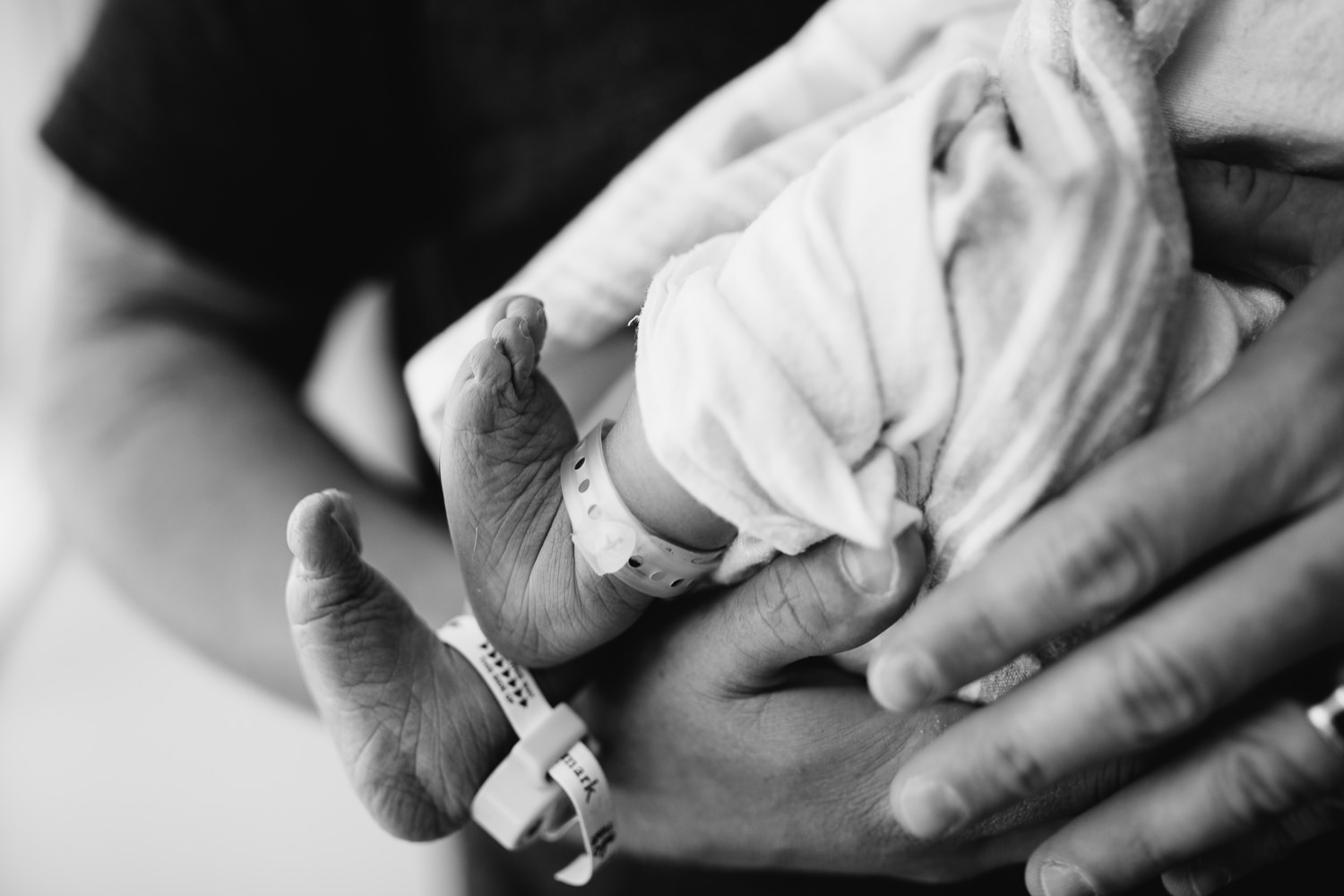 dad holding newborn baby girl - Markham hospital photography