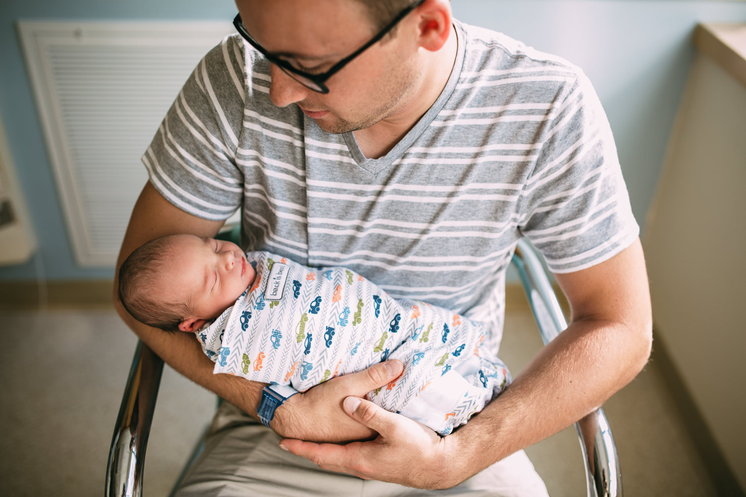 new dad holding newborn baby boy in hospital - Newmarket fresh 48 photographer