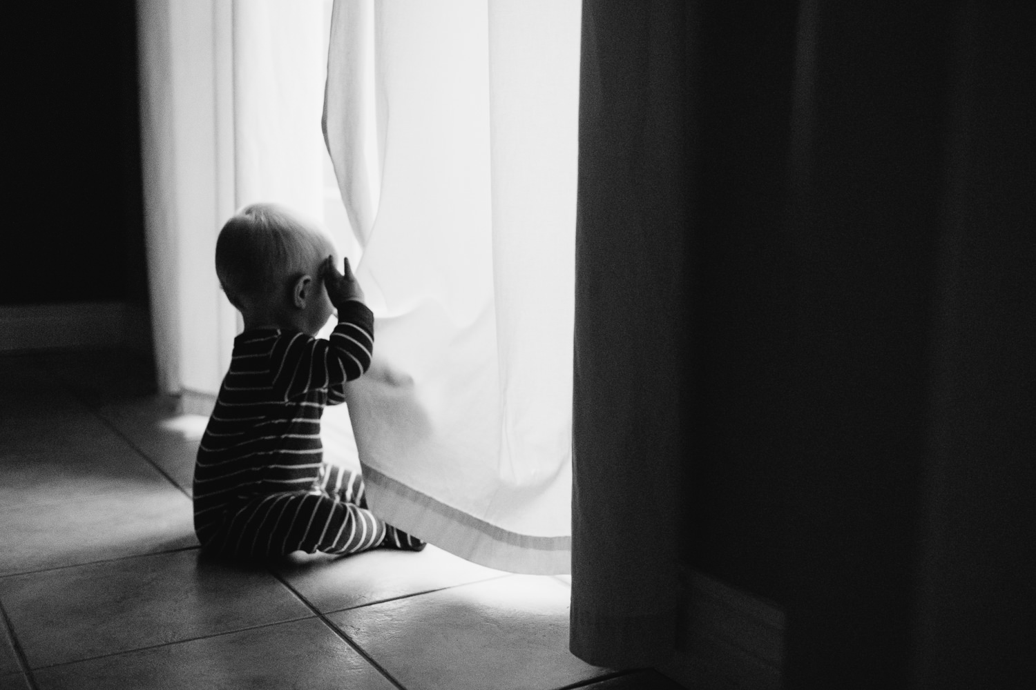 1 year old baby boy looking out window - Uxbridge child photography