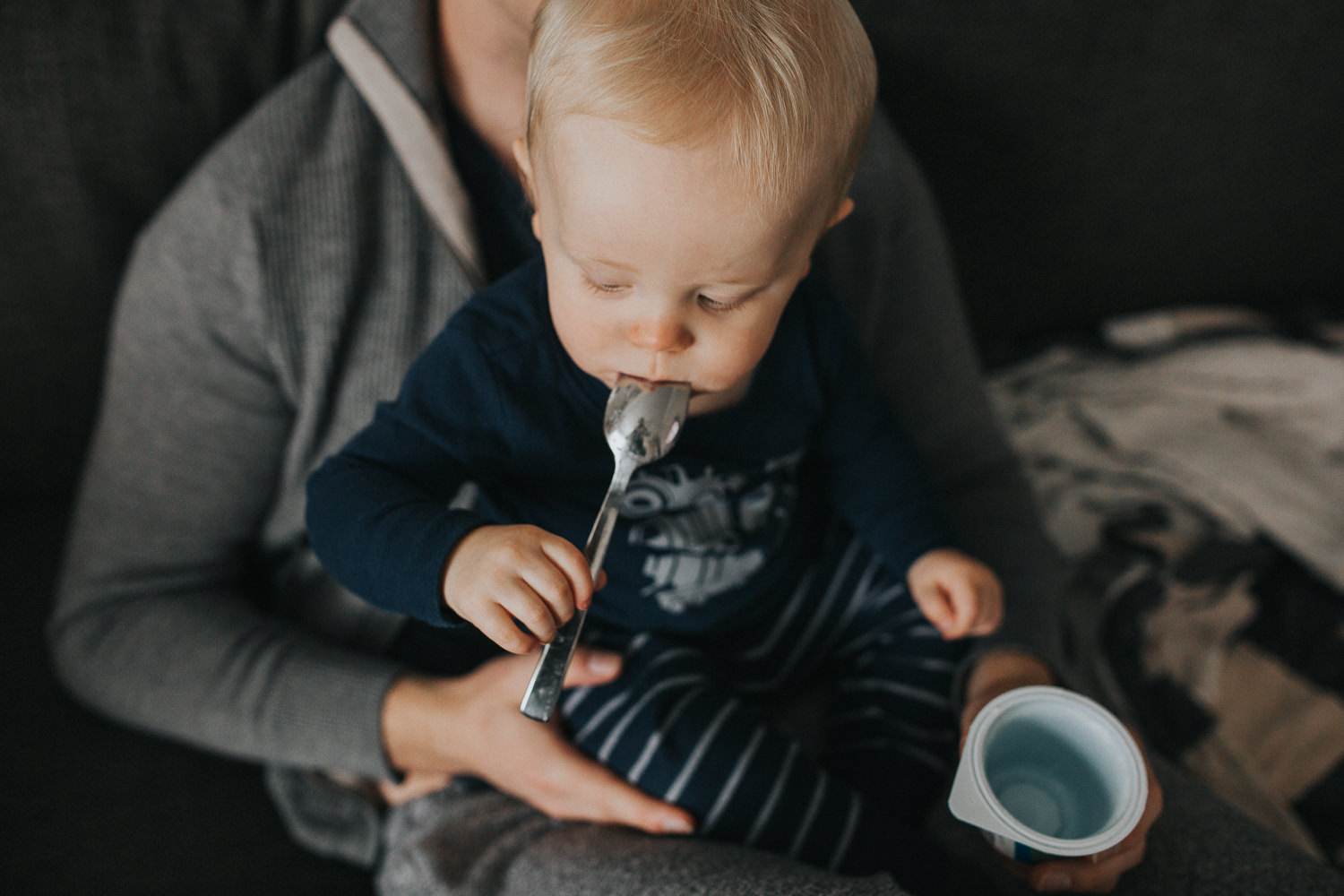1 year old eating yogurt on couch with father - Uxbridge lifestyle photography