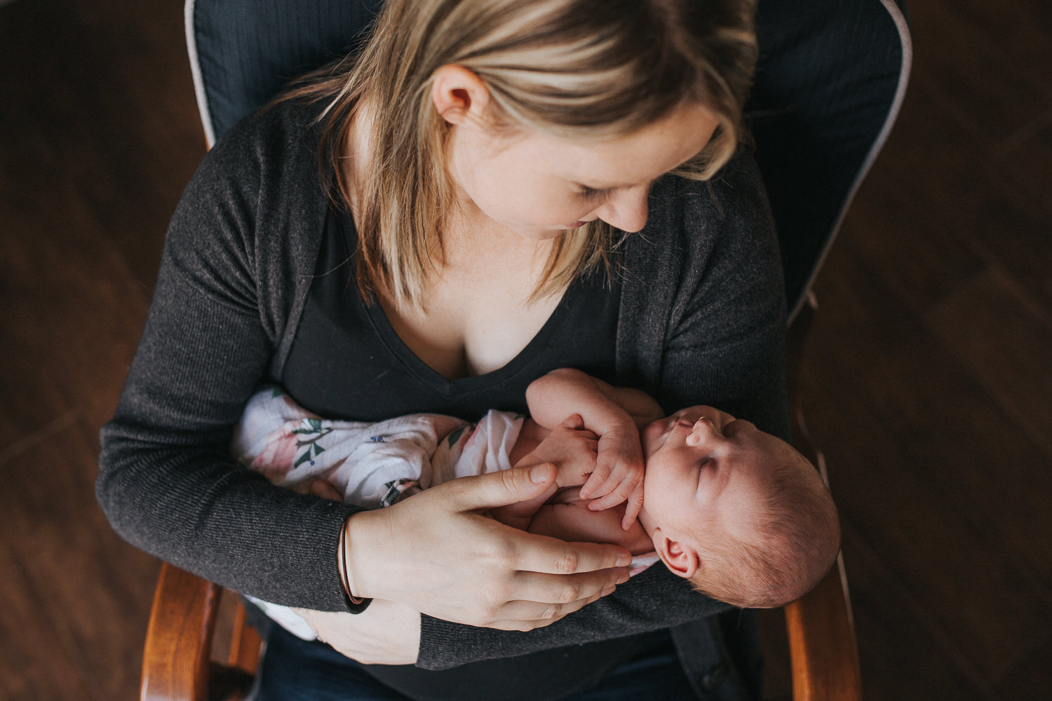 mom holding 1 week old baby girl in rocking chair - Uxbridge newborn photographer