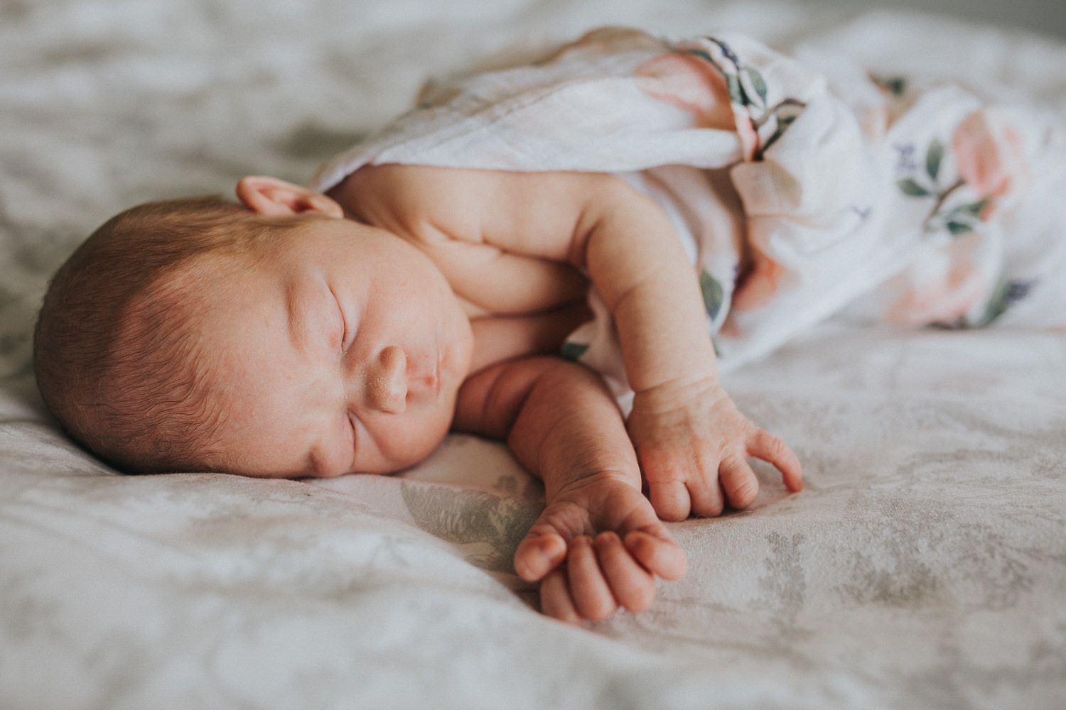 Newborn baby girl asleep on bed - Uxbridge newborn photographer