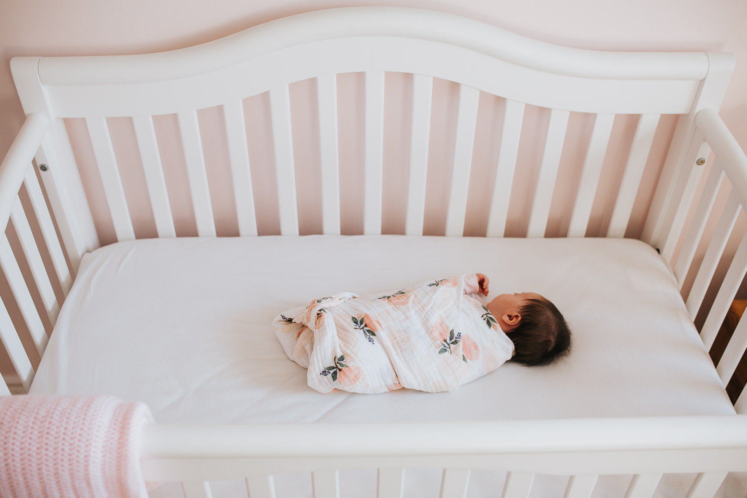 1 month old baby girl lying in crib in pink nursery - Uxbridge lifestyle photography