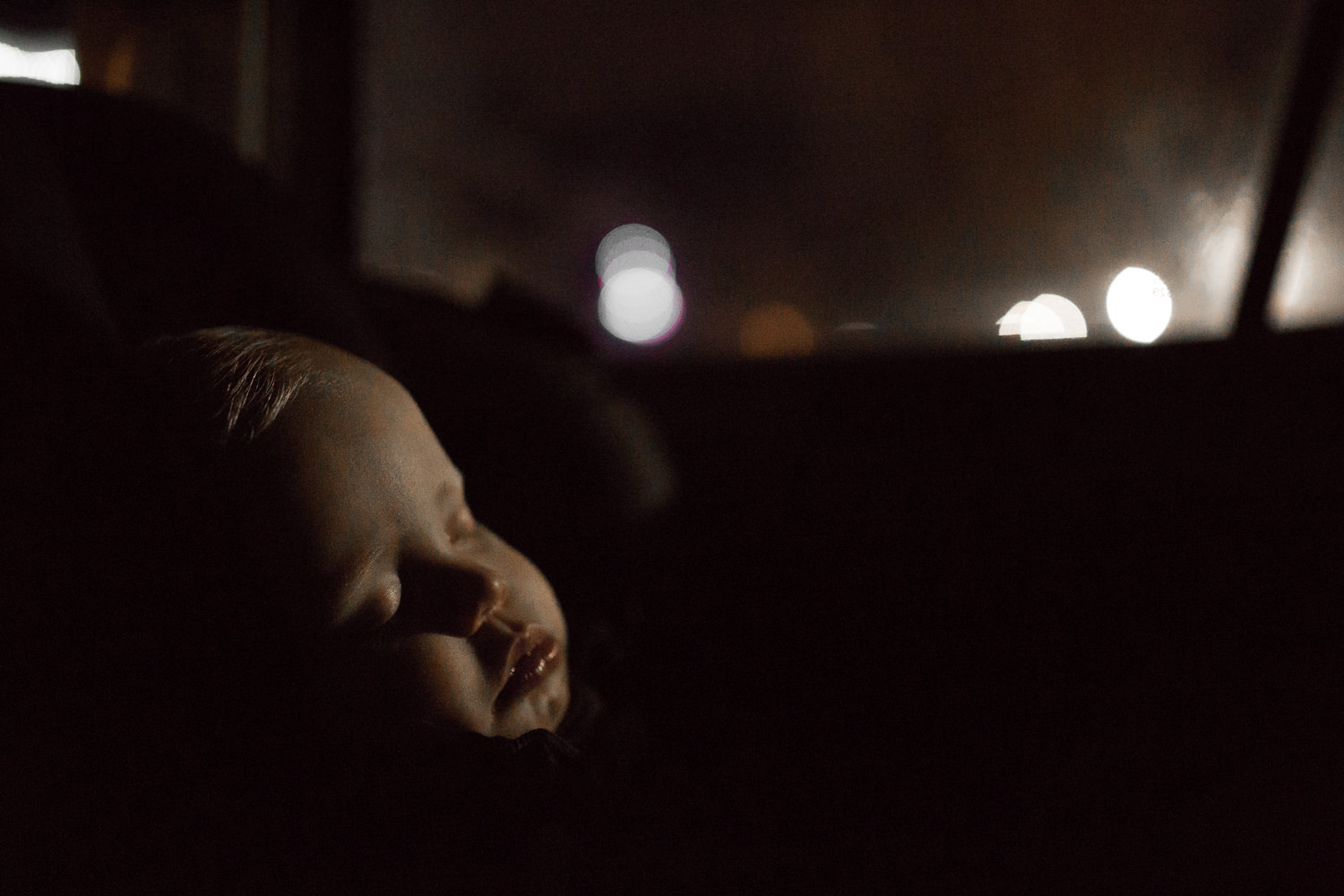 1 year old baby boy asleep in car seat at night - Stouffville Child photos