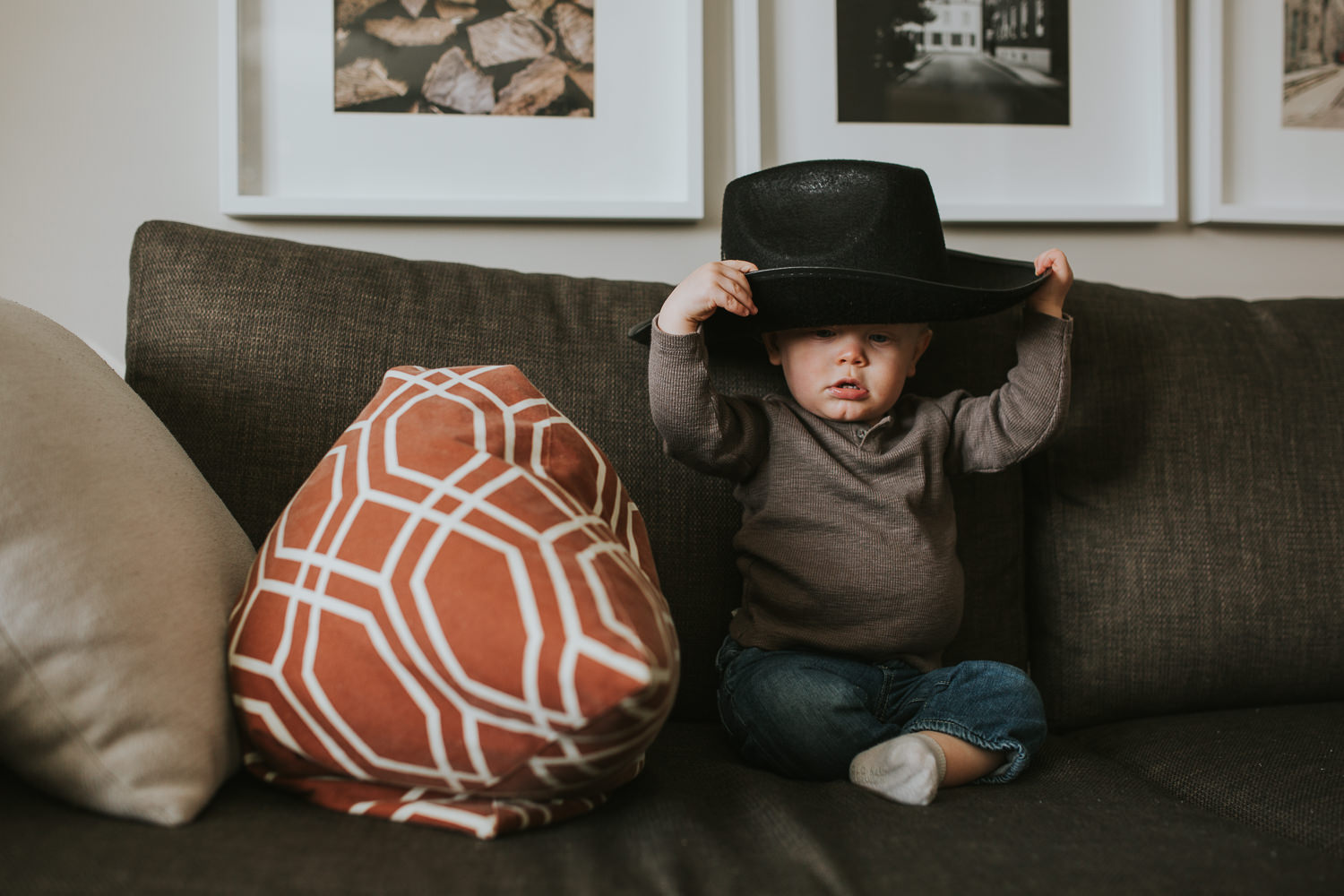 1 year old toddler boy putting on cowboy hat - markham child photography