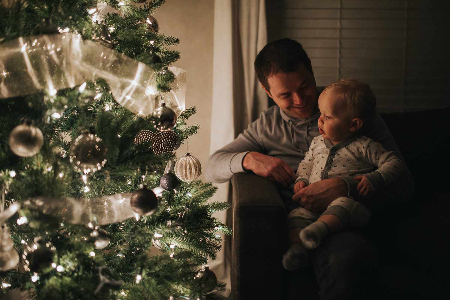 1 year old toddler boy with dad looking at christmas tree - Stouffville in-home photography