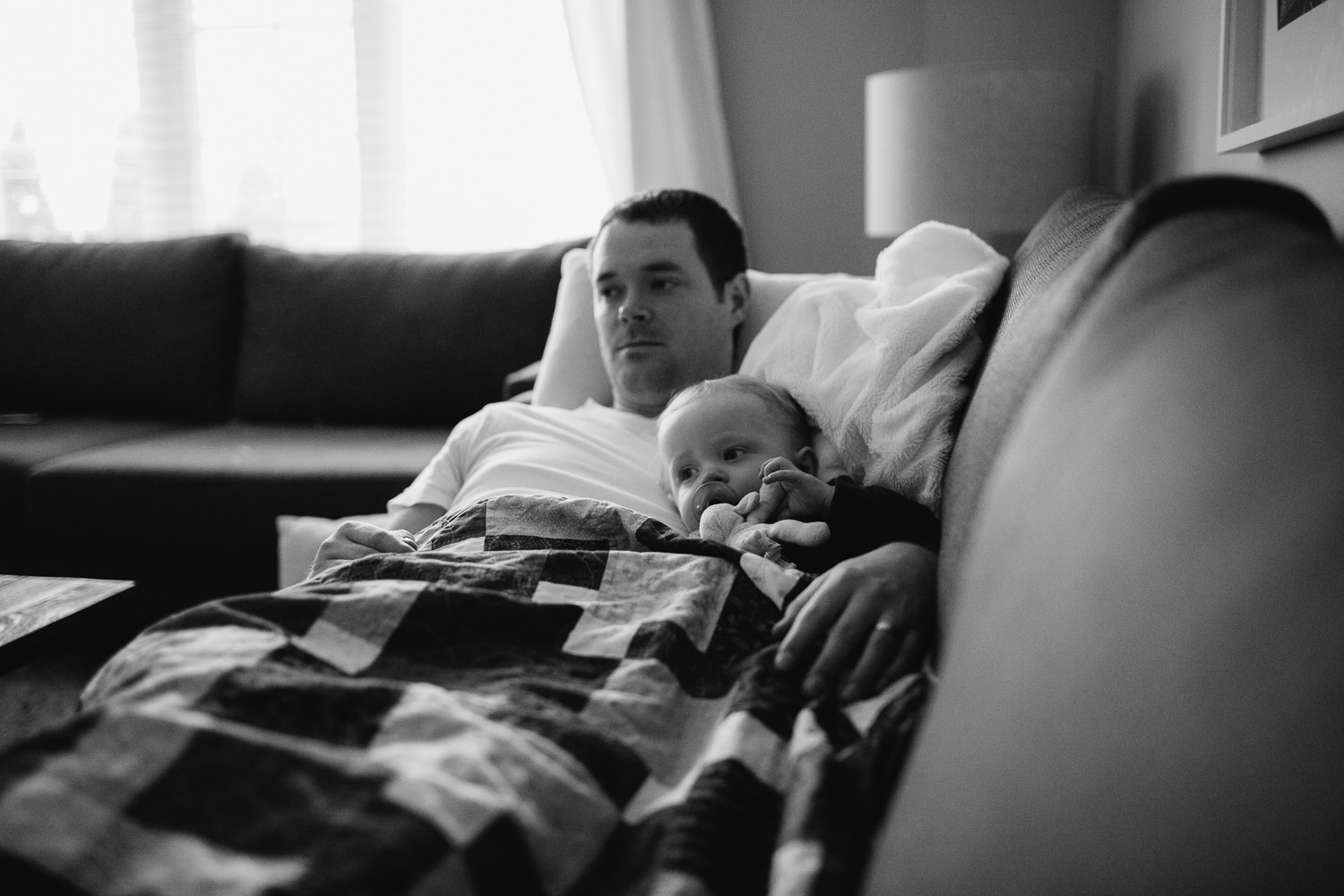 1 year old toddler boy lying with father on couch - Newmarket lifestyle photos