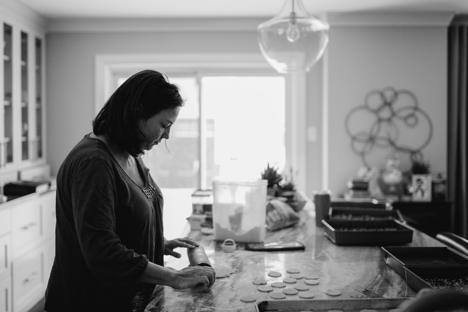 woman baking christmas cookies in large kitchen - uxbridge in-home photography