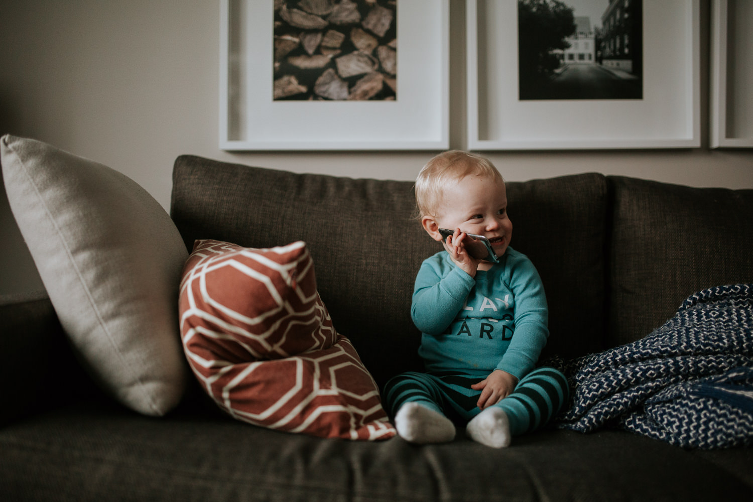 1 year old baby boy on couch talking on phone - stouffville lifestyle photography