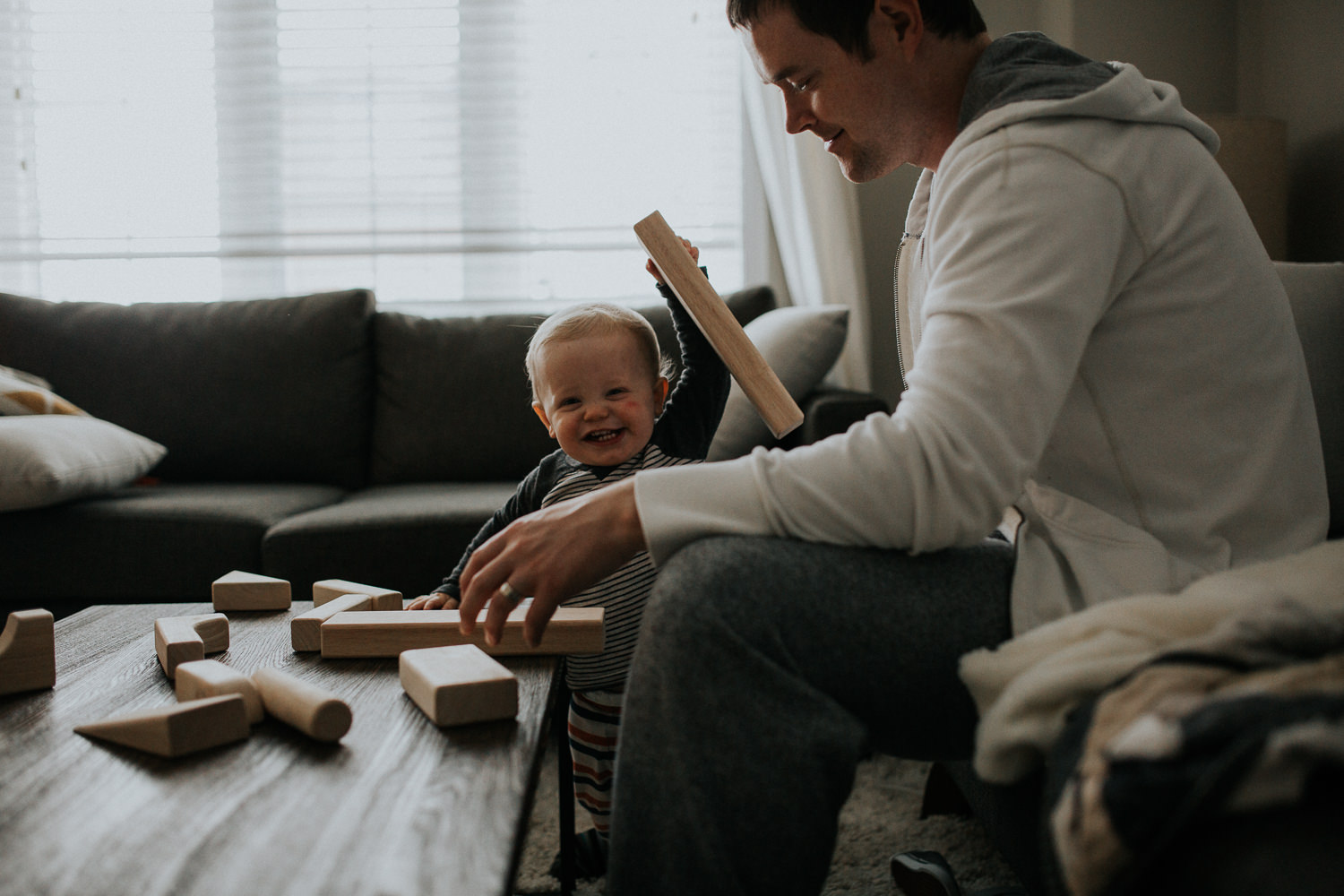 1 year old toddler boy and dad playing with wooden blocks - markham in-home photos