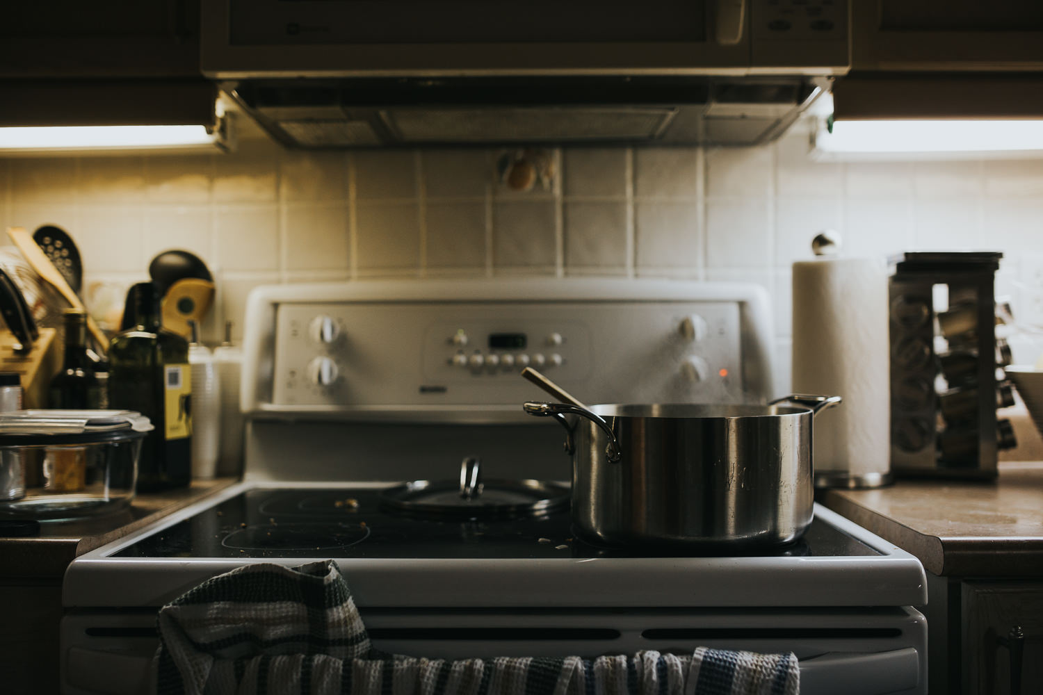 pot of chicken noodle soup cooking on white stove - uxbridge in-home photography