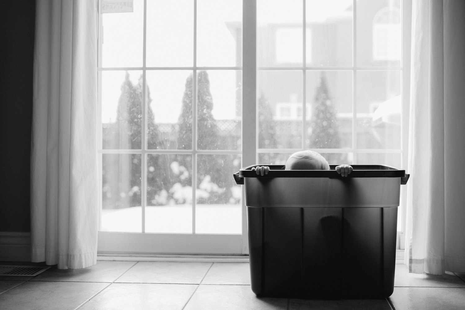 1 year old toddler boy hiding in plastic bin - stouffville child photography