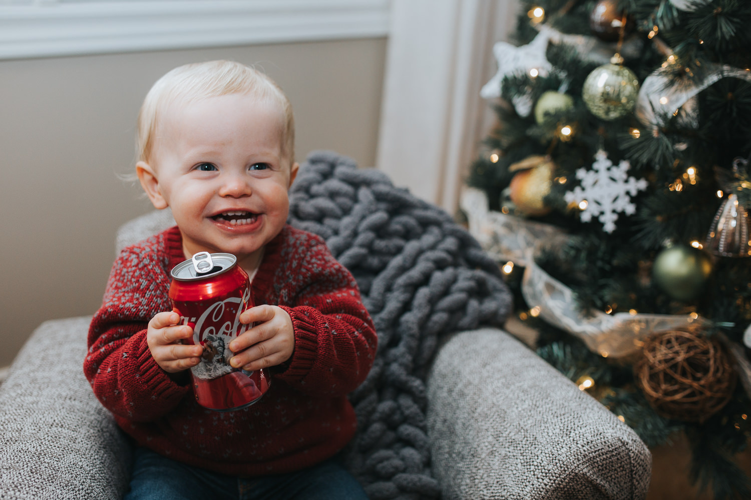 1 year old toddler boy with can of coca cola beside christmas tree - markham child photos