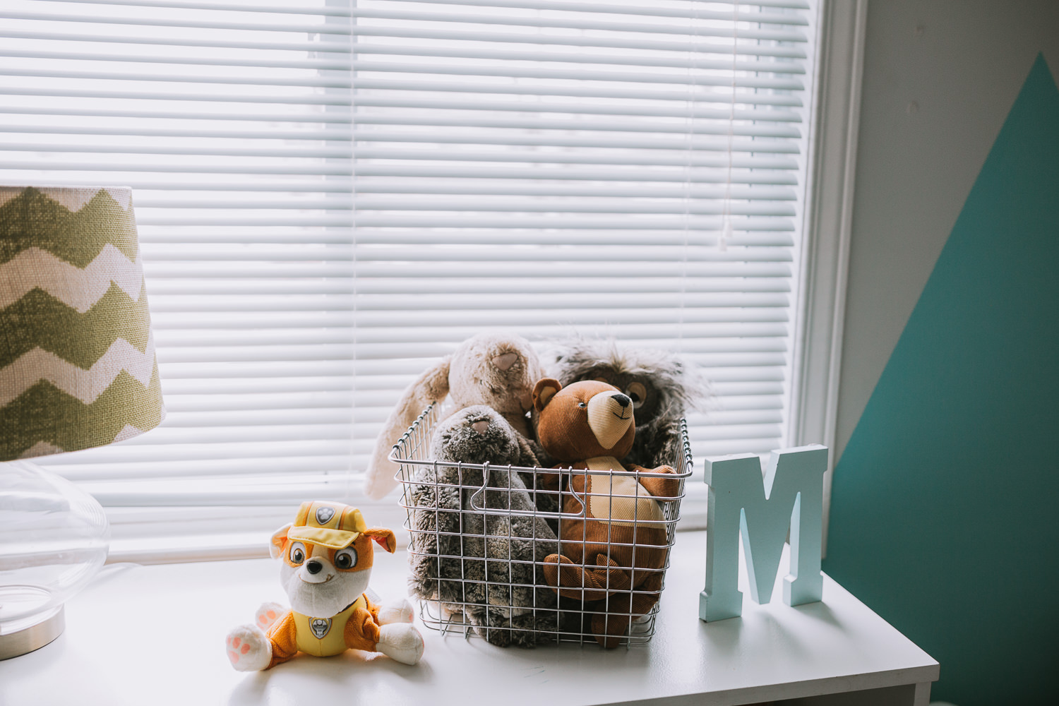 basket of stuffed animals in basket on bedroom dresser - newmarket lifestyle photos